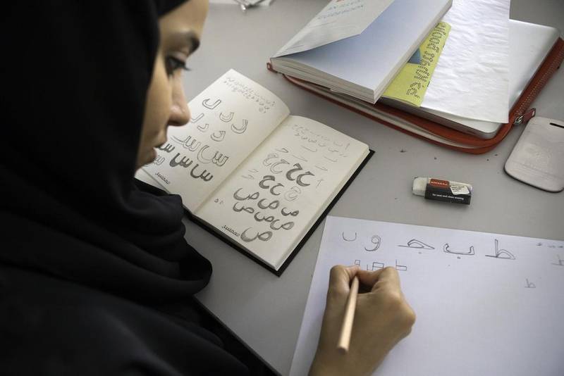 A student practices her writing at an Arabic typography workshop in Dubai. Jaime Puebla / The National