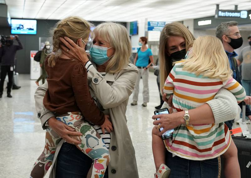 Maureen Watkins is reunited with her grandchildren upon her arrival from London at Dulles International Airport in Chantilly, Virginia, on November 8, 2021. Reuters