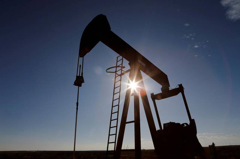 FILE PHOTO: The sun is seen behind a crude oil pump jack in the Permian Basin in Loving County, Texas, U.S., November 22, 2019. REUTERS/Angus Mordant/File Photo