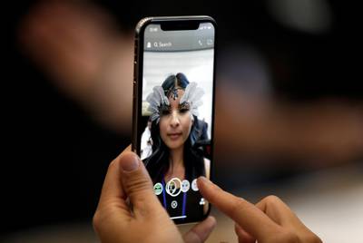 The new iPhone X is displayed in the showroom after the new product announcement at the Steve Jobs Theater on the new Apple campus on Tuesday, Sept. 12, 2017, in Cupertino, Calif. (AP Photo/Marcio Jose Sanchez)