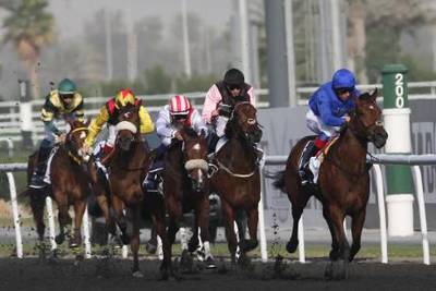 Dubai, United Arab Emirates, Jan 6 2012, Meydan , Dubai World Cup Carnival, Race 2- (right blue silks) #1 GAMILATI ridden by Lanfranco Dettori and trained by Mahmoud Al Zarooni  breaks free at the 200m pole to win race 2. Mike Young / The National?