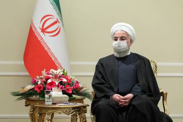 In this photo released by the official website of the office of the Iranian Presidency, President Hassan Rouhani meets with Irish Foreign Minister Simon Coveney, in Tehran, Iran, Sunday, March 7, 2021.Iranian Presidency Office via AP