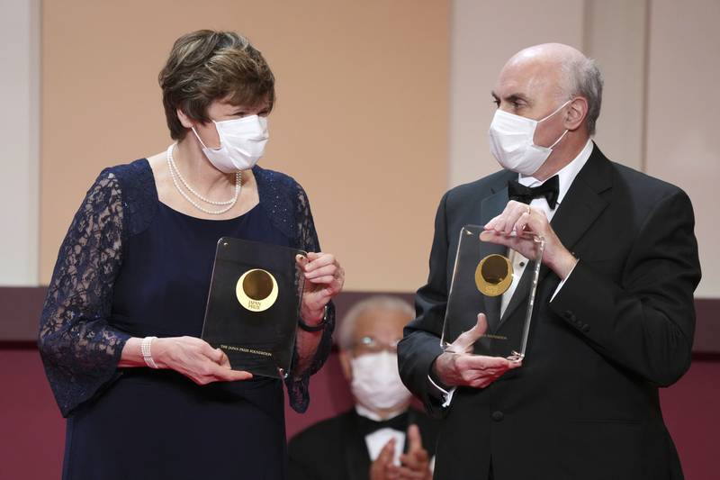 Dr Katalin Kariko and Dr Drew Weissman pose with trophies during a presentation ceremony for the Japan Prize. AP