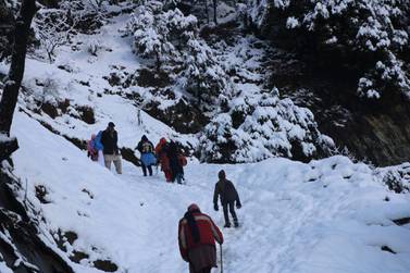 People walk on a snow-covered mountain path in Neelum valley, Pakistan-administered Kashmir. Dozens of people have been killed in avalanches and heavy snowfall in Pakistan, India and Afghanistan. EPA