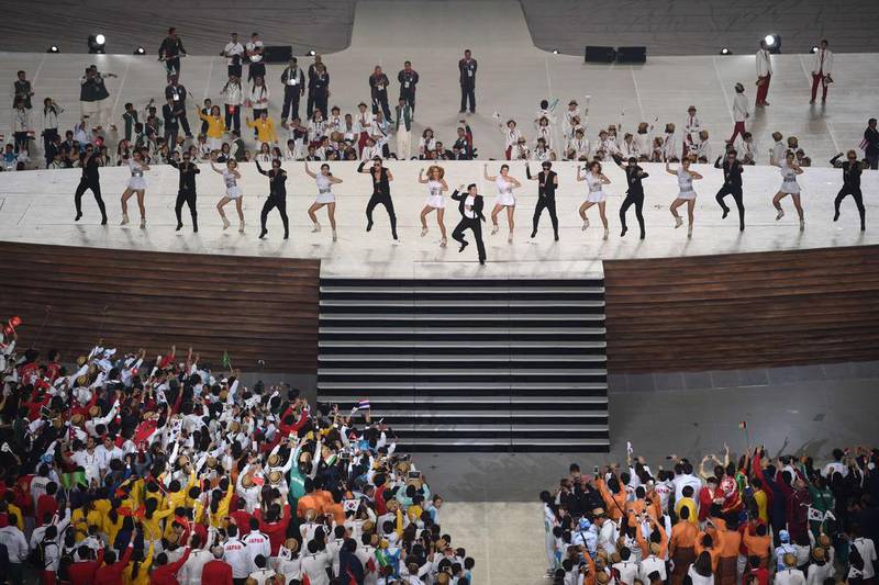 South Korean pop star Psy, centre, dance the 2014 Asian Games into action at the Incheon Asiad Main Stadium on September 19, 2014. Ed Jones /  AFP