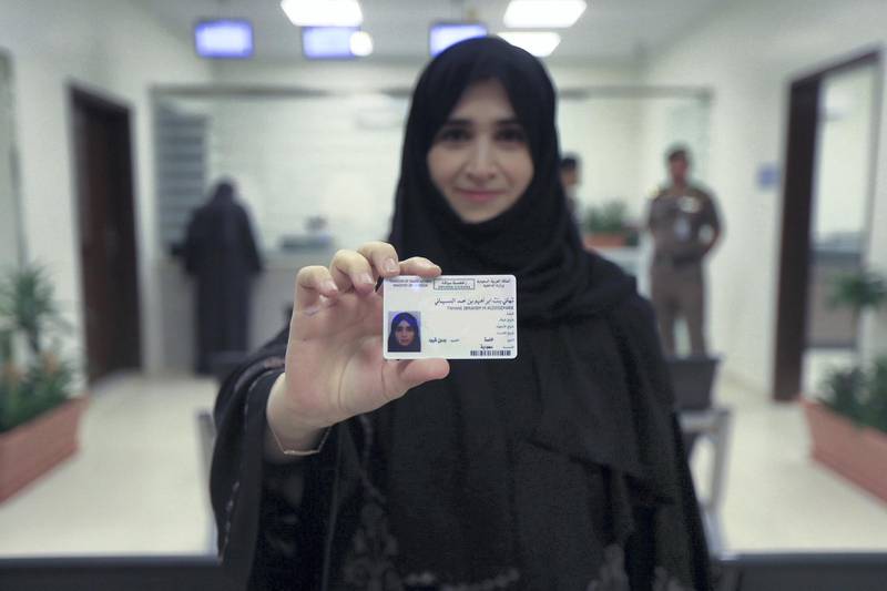 Tahani Aldosemani smiles as she brandishes her brand new driving licence issued on Monday June 4 by Saudi Arabia. CIC / Ministry of Media