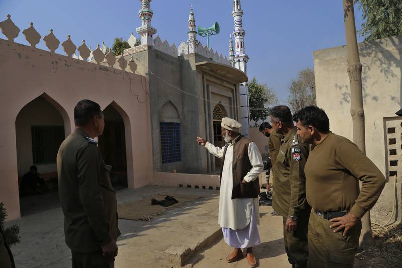 Mosque custodian Mian Mohammad Ramzan, centre, tells police what he saw. Mob attacks on people accused of blasphemy are common in Pakistan. AP