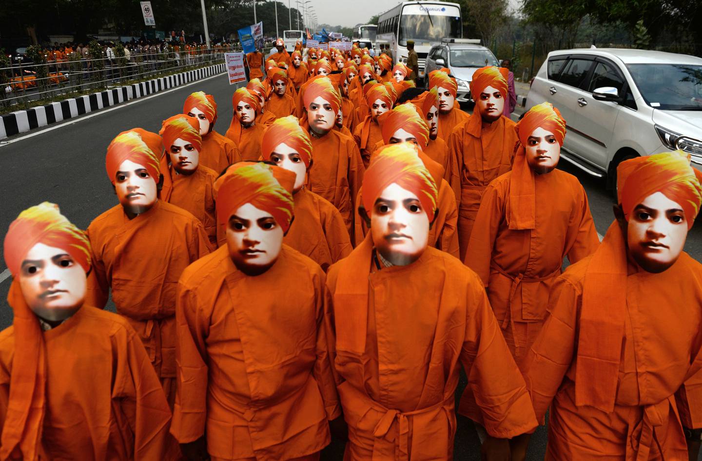 Indian students wear the face masks and attire of Indian scholar monk Swami Vivekananda at a rally on ocassion to mark his birth anniversary in Chennai on January  20, 2018.
Vivekananda is considered a major force in the revival of Hinduism in modern India. / AFP PHOTO / ARUN SANKAR
