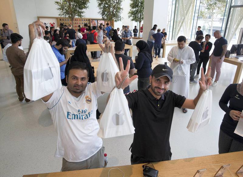 DUBAI, UNITED ARAB EMIRATES, 21 SEPTEMBETR 2018 - Apple fans with their purchased iPhones at the launch of iPhone XS at Apple store, Dubai Mall.  Leslie Pableo for The National for Alkesh Sharma’s story