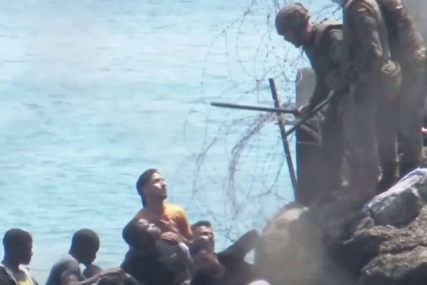 Spanish troops use smoke bombs and batons on migrants at Moroccan border