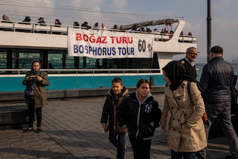 A price banner for a tour of the Bosphorus Strait on the side of a passenger ferry in Istanbul