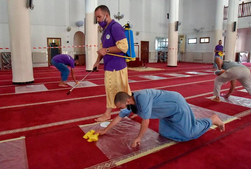 Algerian volunteers desinfect the prayer hall ahead of the noon prayer at the El Fateh mosque in the El Afia de Kouba neighbourhood of the capital Algiers, as the country eases Covid-19 restrictions. AFP