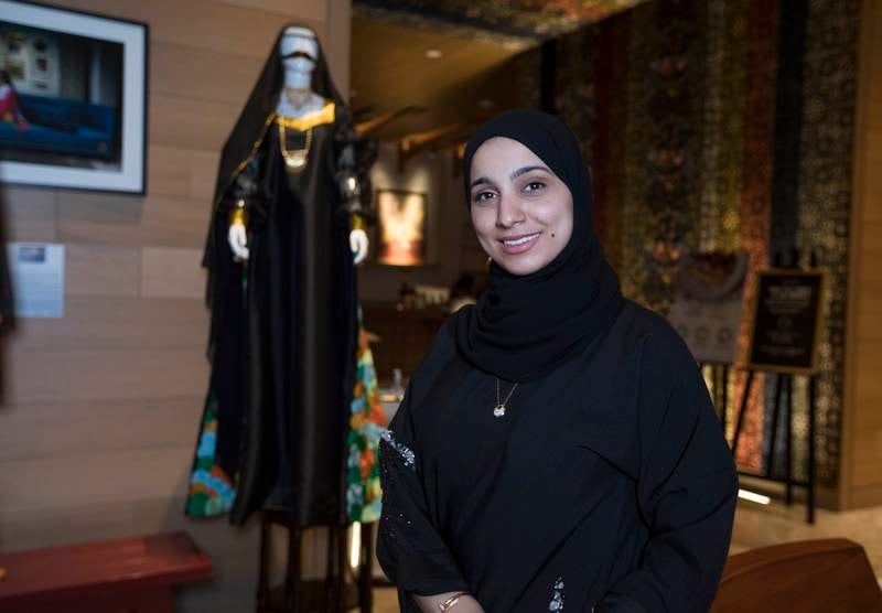 Marwa BenSlil, one of the five finalists of the design competition, poses alongside her garment.