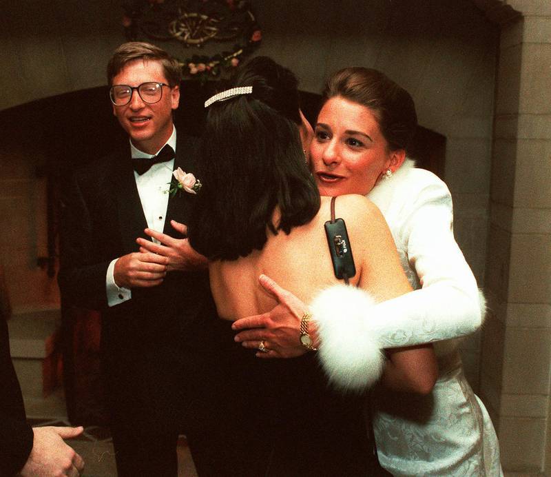 In this Jan. 9, 1994, file photo, computer mogul Bill Gates III and bride Melinda French greet guests in a reception line at a private estate in Seattle. The couple was married in Hawaii the week prior. AP Photo