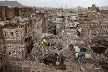 Workers clear rubble from a house damaged by rain in the old city of Sanaa, a Unesco World Heritage site in Yemen, on August 9, 2020. Reuters