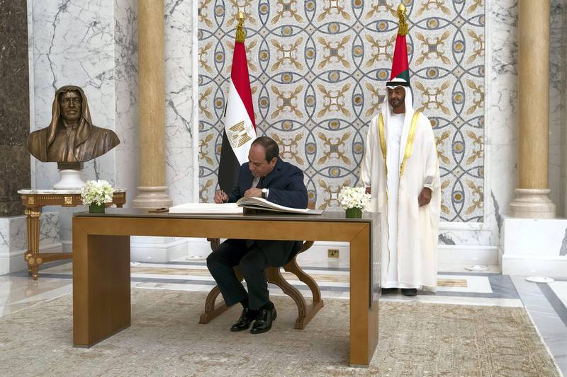 ABU DHABI, UNITED ARAB EMIRATES - November 14, 2019: HE Abdel Fattah El Sisi, President of Egypt (C), signs the guest book during a state visit at Qasr Al Watan Seen with HH Sheikh Mohamed bin Zayed Al Nahyan, Crown Prince of Abu Dhabi and Deputy Supreme Commander of the UAE Armed Forces (back R).

( Eissa Al Hammadi for the Ministry of Presidential Affairs )
---