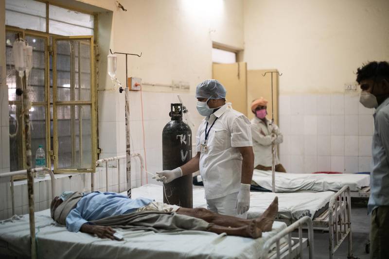 A medical worker treats a patient suspected to be suffering from the coronavirus in the emergency ward at the BDM Government Hospital, in Jaipur District, Rajasthan, India. Getty