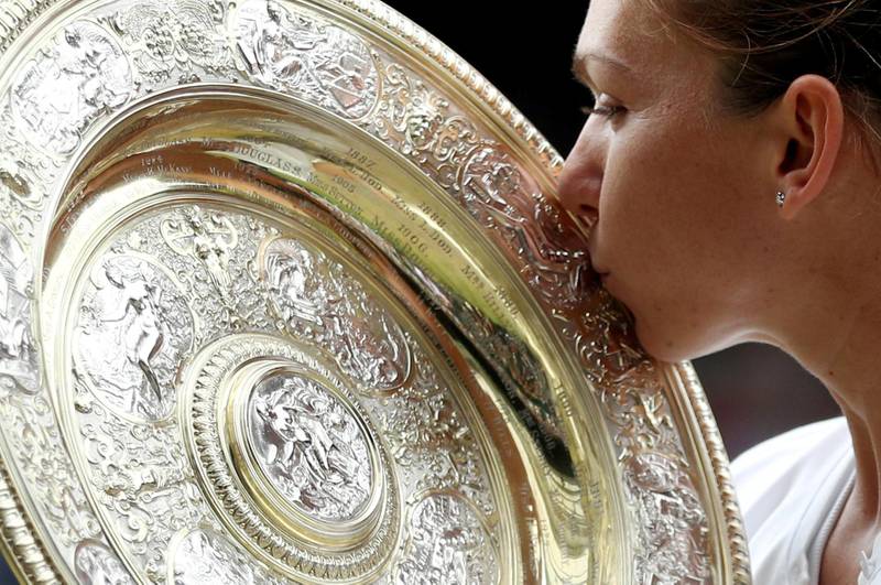 Simona Halep kisses the trophy as she celebrates after winning the Wimbledon women's final against Serena Williams on Saturday. Reuters