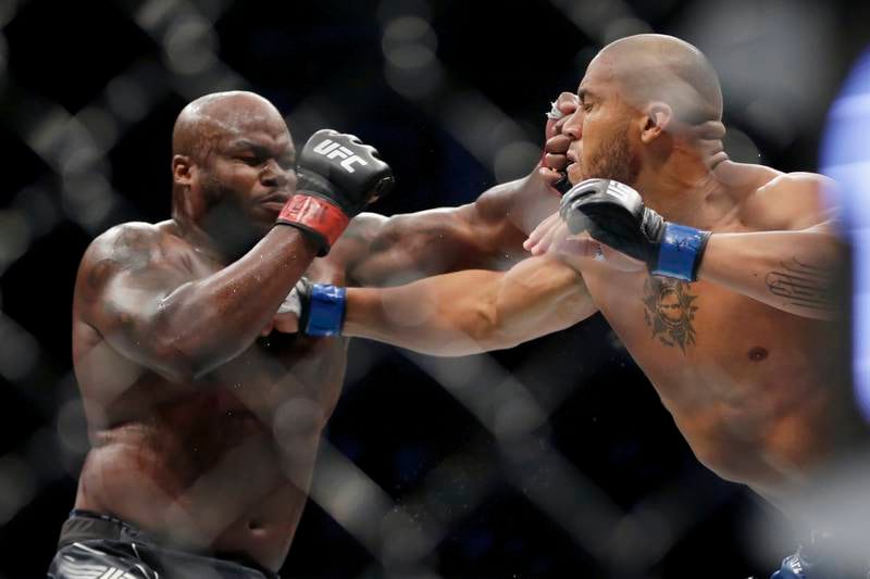 Derrick Lewis, left, takes a punch from Ciryl Gane. AP Photo