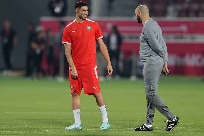 Morocco's coach Walid Regragui with defender Achraf Hakimi during a training session. AFP