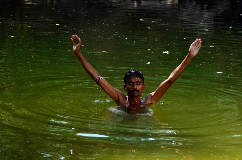 Hindu devotee Hansraj Kothi immerses himself in the Ganga Pond, which is considered sacred by Pakistani Hindus in the area of Sardhra Nagarparkar. Washing oneself in the water is considered a way for devotees to cleanse their sins. Mobeen Ansari