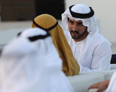 Dubai's Crown Prince Sheikh Hamdan bin Mohammed bin Rashid Al-Maktoum (R), is pictured during a ceremony presenting the new logo of Dubai Airoprt, in Dubai, on February 13, 2019. / AFP / KARIM SAHIB
