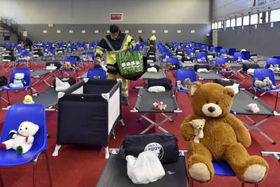 A worker prepares a gym in Perpignan, France, before the arrival of people fleeing Ukraine. AFP