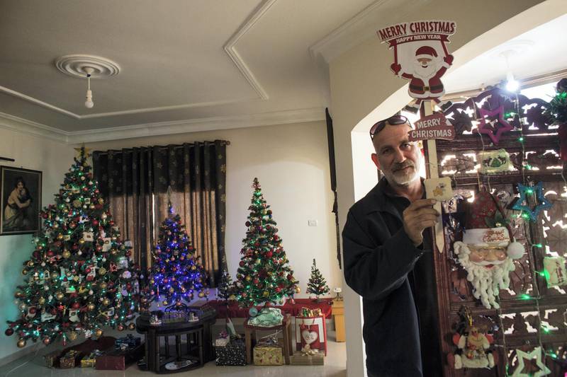 Palestinian Greek Orthodox Boulous  Elias Azzam with his Christmas decorations at his home in Gaza City on December 22,2018 . Bouris has two sisters that live in the USA and Canada that he has not seen in 25 years.

He spent weeks decorating his Christmas trees  and hopes that the electricity cuts will not happen during his upcoming Christmas celebration.(Photo by Heidi Levine for The National).