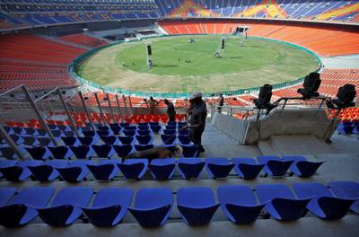 A member of a bomb disposal squad from Gujarat Police uses a sniffer dog to scan the stands at Sardar Patel Gujarat Stadium. Reuters