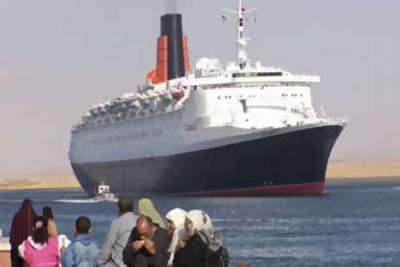 The Queen Elizabeth 2 passes through the Suez Canal on the way to its new home in Dubai.