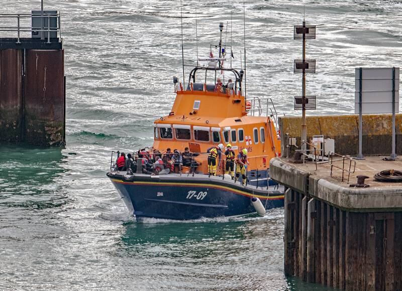 Migrants brought ashore by lifeboat at Dover Docks in southern England. EPA