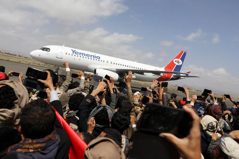 Relatives cheer as the plane lands. Reuters