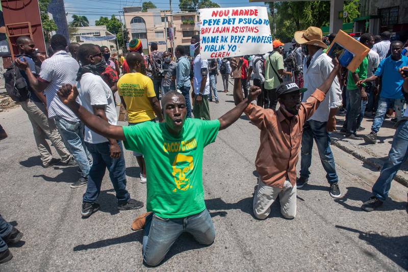 Haitian protesters, who denounce the climate of insecurity in the country, gather in the vicinity of the Ministry of Justice and Public Security, before being pushed back by the Haitian National Police, in Port-au-Prince, Haiti. EPA