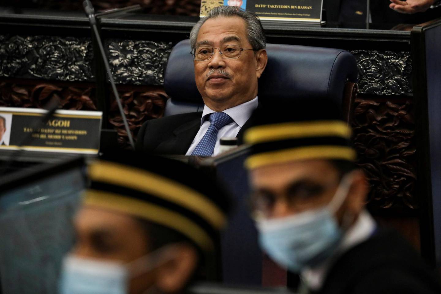 FILE PHOTO: Malaysia's Prime Minister Muhyiddin Yassin reacts during a session of the lower house of parliament, in Kuala Lumpur, Malaysia July 13, 2020. REUTERS/Lim Huey Teng/File Photo