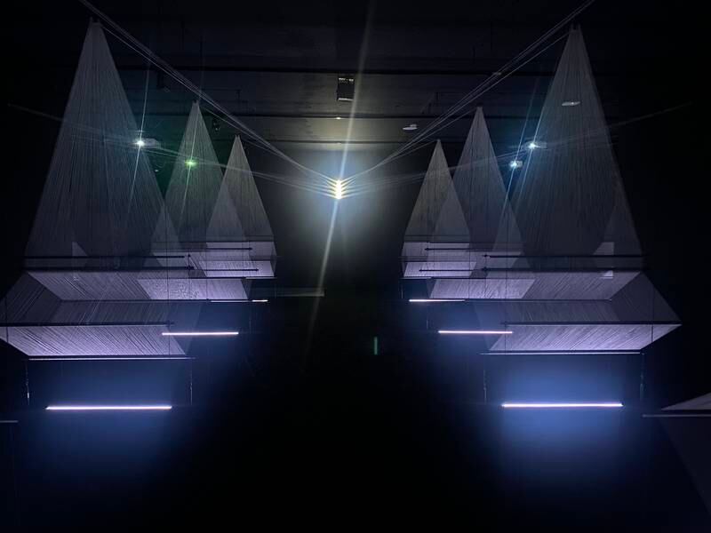 Saudi artist Muhannad Shono's Letter in Light, Lines We Write (2023) takes viewers on a spiritual journey with a stunning thread, steel and light projection installation. Hareth Al Bustani / The National