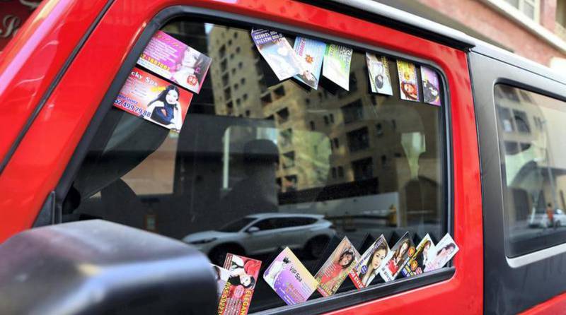 Massage parlour cards are often placed on vehicles in city centres. Pawan Singh / The National