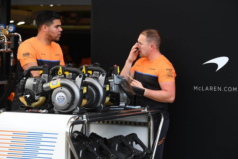 Members of the McLaren team work in pit lane at the Albert Park circuit ahead of the Formula One Australian Grand Prix in Melbourne on March 11, 2020. -- IMAGE RESTRICTED TO EDITORIAL USE - STRICTLY NO COMMERCIAL USE --
 / AFP / William WEST / -- IMAGE RESTRICTED TO EDITORIAL USE - STRICTLY NO COMMERCIAL USE --
