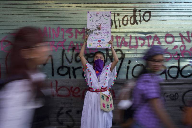 A woman holds a sign during march against gender-based violence, in Mexico City. AP