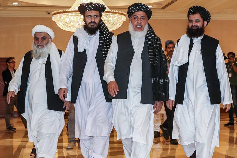 (FILES) In this file photo taken on July 8, 2019, Mohammad Nabi Omari (C-L), a Taliban member formerly held by the US at Guantanamo Bay and reportedly released in 2014 in a prisoner exchange, Taliban negotiator Abbas Stanikzai (C-R), and former Taliban intelligence deputy Mawlawi Abdul Haq Wasiq (R) walk with another Taliban member during the second day of the Intra Afghan Dialogue talks in the Qatari capital Doha. An Afghanistan peace agreement that the US seems close to reaching with the Taliban has prompted worries that President Donald Trump's eagerness to withdraw US troops risks worsening the  civil war and again creating a haven for terrorists. Trump said on August 17, 2019 he was pleased with talks on ending the war, 18 years after the September 11, attacks that prompted the US invasion of Afghanistan in the first place. / AFP / KARIM JAAFAR

