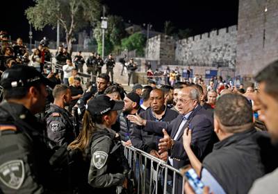 Israeli Arab politician Ahmad Tibi speaks to members of the Israeli security forces as Palestinian protesters gather at the Damascus Gate in Jerusalem's Old City. AFP