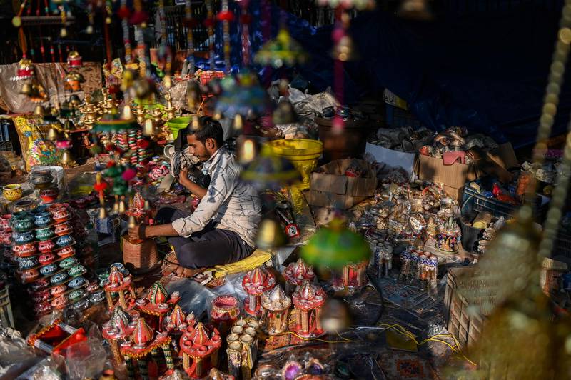 A street vendor sells decorative items at a market in New Delhi. AFP