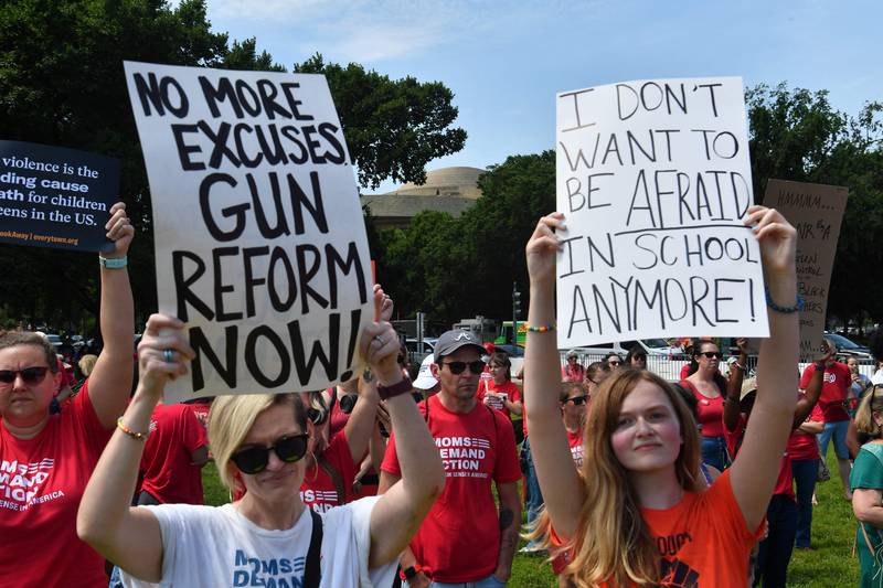 Gun control activists hold up signs in Washington. AFP