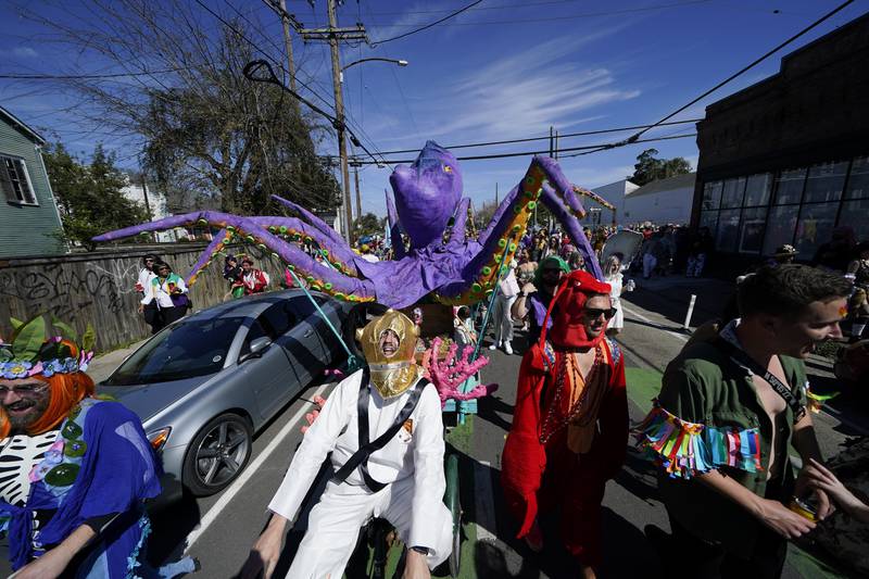 People march the Societe de Sainte Anne parade route during Mardi Gras on Tuesday in New Orleans. AP