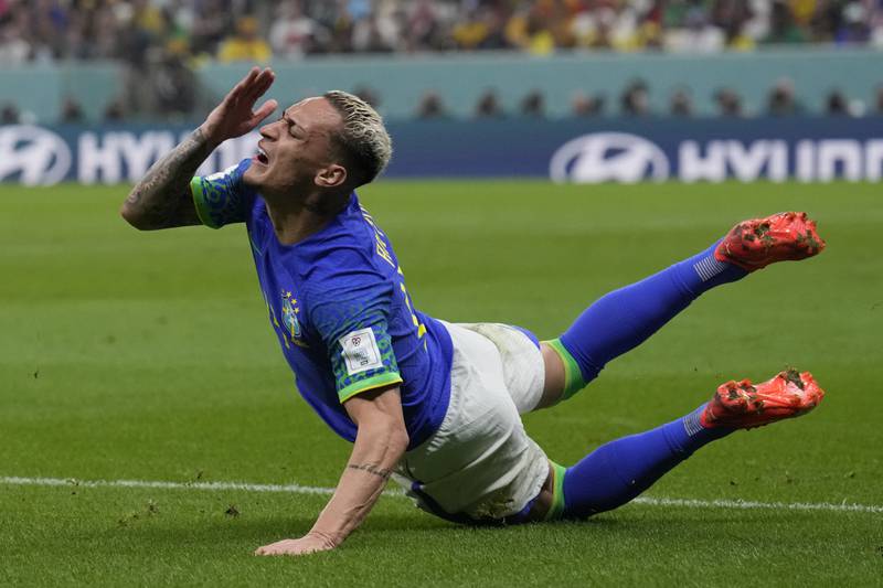 Brazil winger Antony goes down after a challenge by Cameroon's Tolo Nouhou. AP