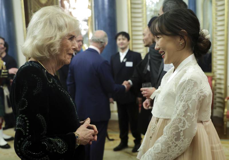Queen Consort Camilla greets a guest at the reception. AP