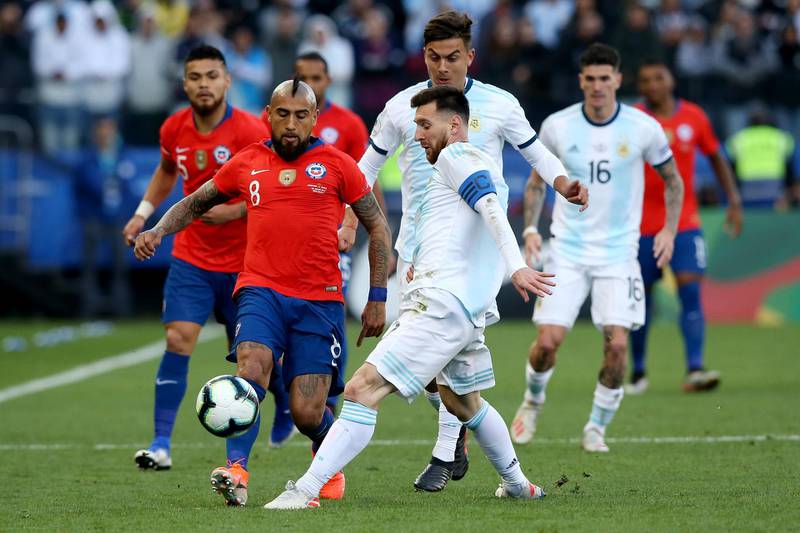 Messi fights for the ball with Arturo Vidal of Chile. Getty