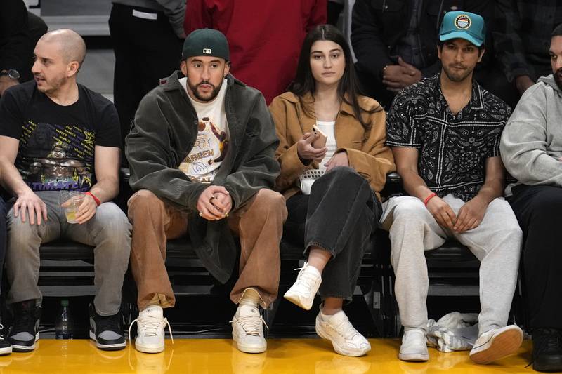 Rapper Bad Bunny, second from left, attends the NBA game between Los Angeles Lakers and Oklahoma City Thunder. AP