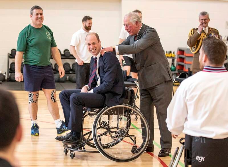 A laughing Prince William is consoled by his father after failing to throw a basketball into the hoop during a visit to a defence medical rehabilitation centre in Loughborough, UK, in 2020.