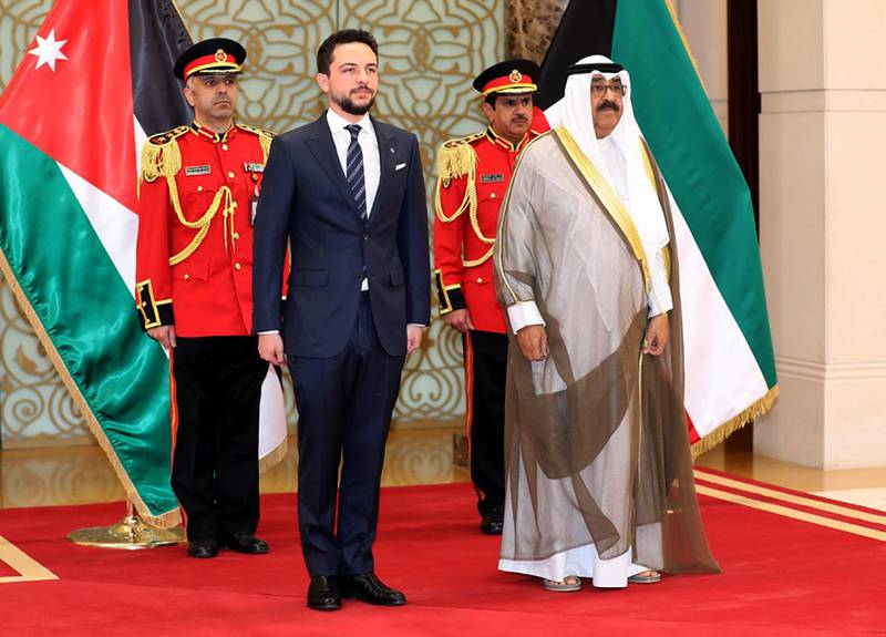Kuwaiti Crown Prince Sheikh Meshal al-Ahmad al-Jaber al-Sabah, right, receives Crown Prince Hussein in Kuwait City. AFP