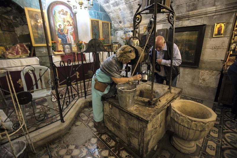 American Christian pilgrims at Jabob's Well in the Saint Photini Church in the Palestinian Balata refugee camp located beside the West Bank city of Nablus.
JacobÕs Well is holy in Christian, Jewish, Muslim and Samaritan teachings: traditions say itÕs where 4,000 years ago the biblical forefather Jacob once camped, and where Jesus also passed through and had a conversation with a Samaritan woman, after whom the church is named. (Photo by Heidi Levine for The National).